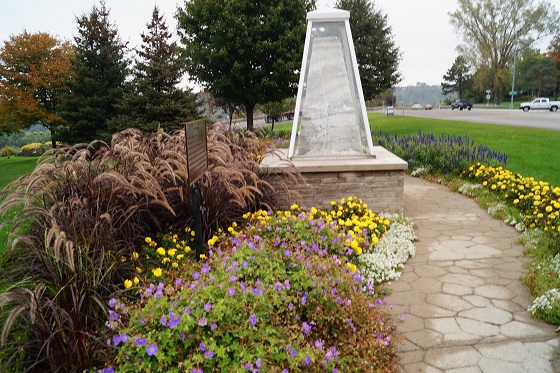 A SALT monument is surrounded by a beautiful garden.